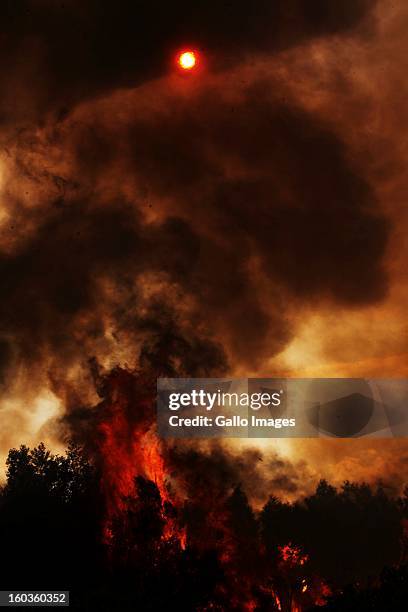 Fire rages through De Hoop farm on January 29 in Paarl, South Africa. No firemen were present as the veld fire swept through the entire Boland region...