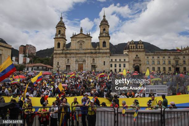 People gather at the Bolivar Square as the former members of the Colombian Military Forces march to protest against Colombian President Gustavo Petro...