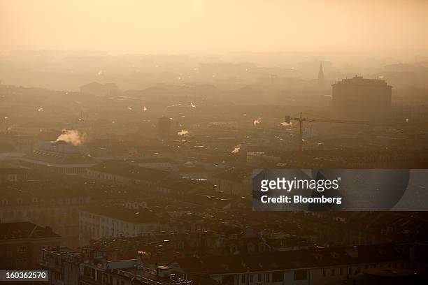 Construction crane is seen amongst buildings and properties from the top of the Mole Antonelliana in Turin, Italy, on Tuesday, Jan. 29, 2013. Italy...