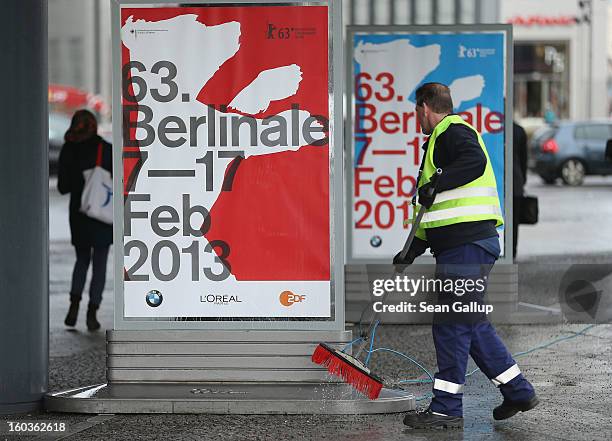 Worker cleans posters advertising the 63rd Berlinale International Film Festival on January 30, 2013 in Berlin, Germany. The 2013 Berlinale will run...