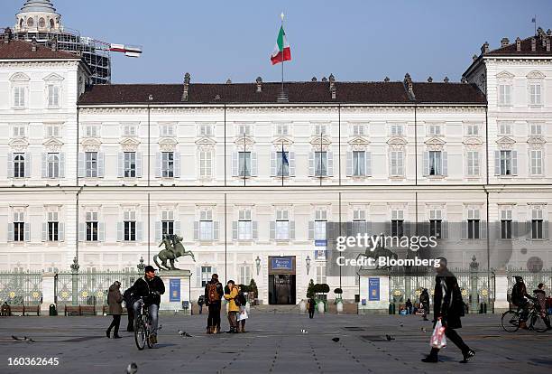 An Italian national flag flies from the roof of a building on Castle Square in Turin, Italy, on Tuesday, Jan. 29, 2013. Italy sold 8.5 billion euros...