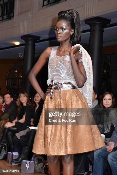 Model walks the runway during the Eric Tibusch Spring/Summer 2013 Haute-Couture show as part of Paris Fashion Week at Hotel D'Evreux on January 21,...