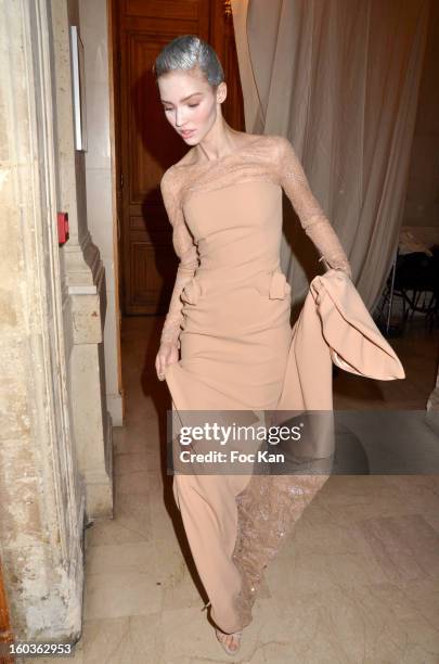 Model leaves the backstage for the runway during the Alexis Mabille Spring/Summer 2013 Haute-Couture show as part of Paris Fashion Week at Mairie du...