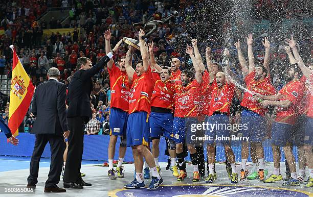 Prince Felipe of Spain handles the gold medals and the trophy to the spanish team during the trophy ceremony after the Men's Handball World...