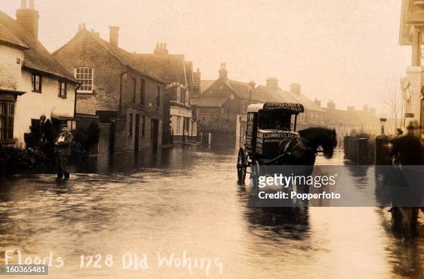 Vintage postcard picturing floods in Woking, Surrey, circa 1910.