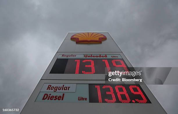 Sign showing fuel prices stands outside a Royal Dutch Shell Plc gas station in London, U.K., on Tuesday, Jan. 29, 2013. Oil traded near the highest...