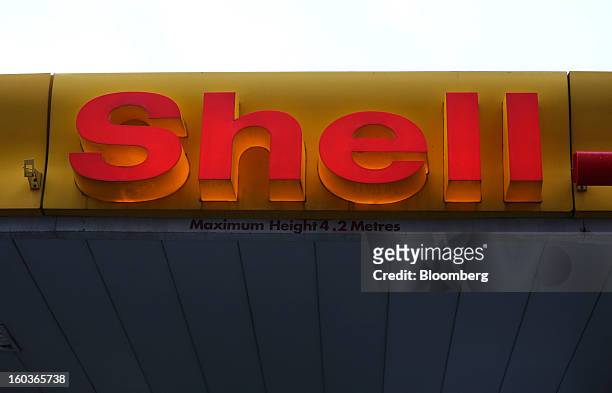 An illuminated sign is seen above the entrance to a Royal Dutch Shell Plc. Petrol station in London, U.K., on Tuesday, Jan. 29, 2013. Oil traded near...