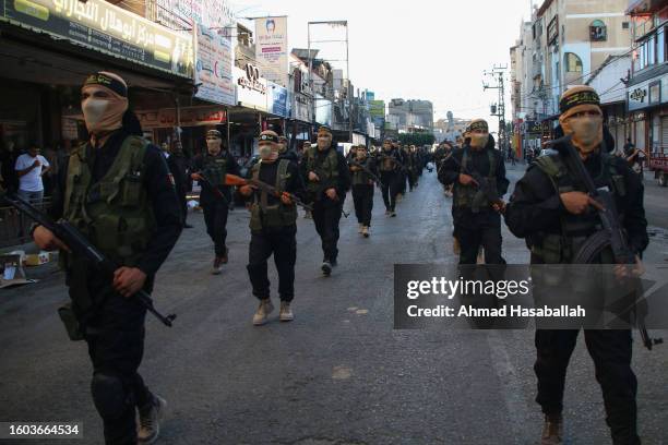 Members of the Al-Quds Brigades, the military wing of the Islamic Jihad movement, march during a military parade on August 9, 2023 in the city of...