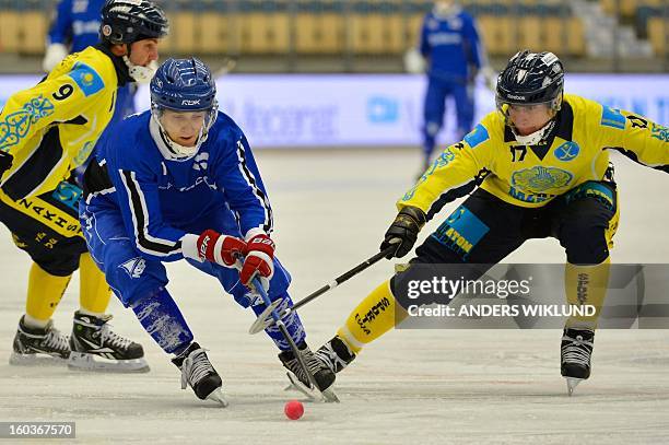 Finland's Markus Kumpuoja and Kazakhstan's Sergey Pochkunov vie for the ball during the Bandy World Championship match Finland vs Kazakhstan in...