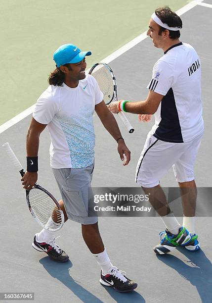 Leander Paes and Purav Raja during a practice session at RK Khanna Tennis Complex in New Delhi on Tuesday.