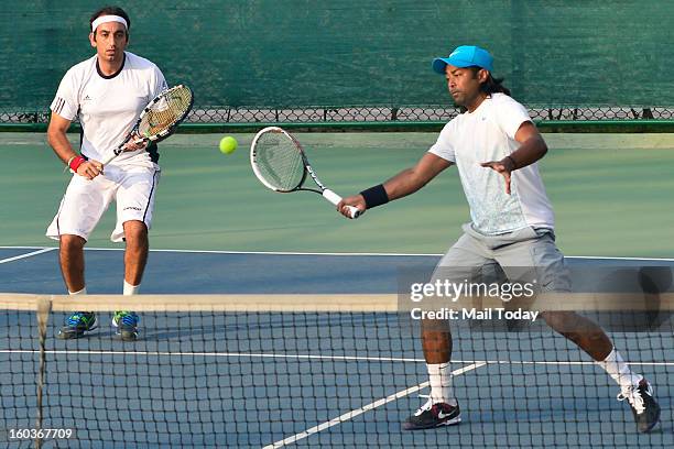 Leander Paes and Purav Raja during a practice session at RK Khanna Tennis Complex in New Delhi on Tuesday.