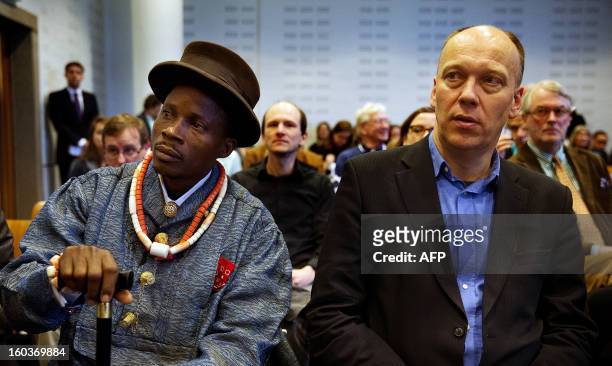 Nigerian farmer Eric Dooh and Geert Ritsema , international campaign leader of Milieudefensie sit in the courthouse of The Hague, The Netherlands, on...