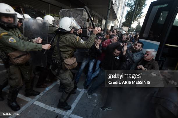 Protesters clash with riot police outside the Labour Ministry in Athens on January 30, 2013. Police were called in on Wednesday to dislodge around 30...