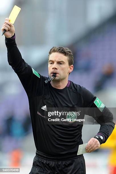 Referee Guido Winkmann shows a yellow card during the Third league match between VfL Osnabrueck and Karlsruher SC at Osnatel Arena on January 26,...