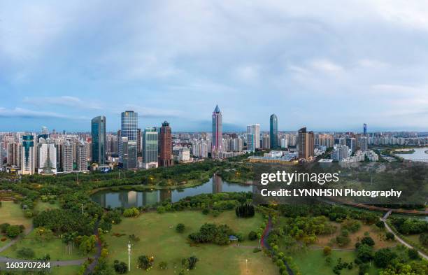 haikou guomao avenue flyover from evergreen garden direction in daylight or blue the hour - lynnhsin stock-fotos und bilder