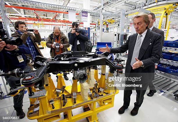 Luca Cordero di Montezemolo, chairman of Ferrari SpA, right, gestures as he looks at a Maserati Quattroporte subframe during the inauguration of the...