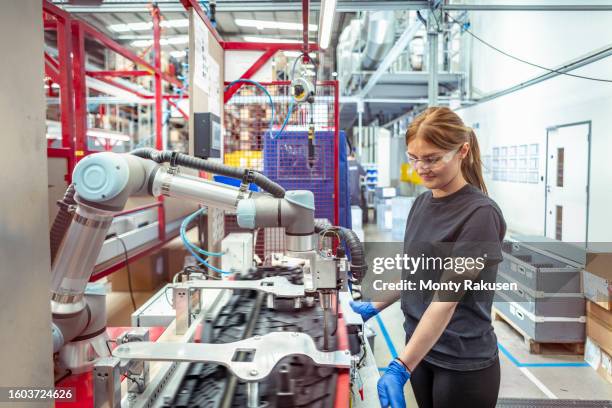 worker working with cobot, robot assembly machine in automotive parts factory - rpa stock pictures, royalty-free photos & images