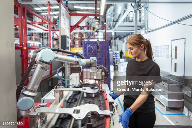 worker working with cobot, robot assembly machine in automotive parts factory - automobile industry stock pictures, royalty-free photos & images