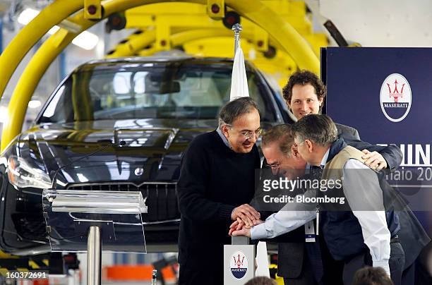 Sergio Marchionne, chief executive officer of Fiat SpA, left, and John Elkann, chairman of Fiat SpA, second right, help officially launch the...