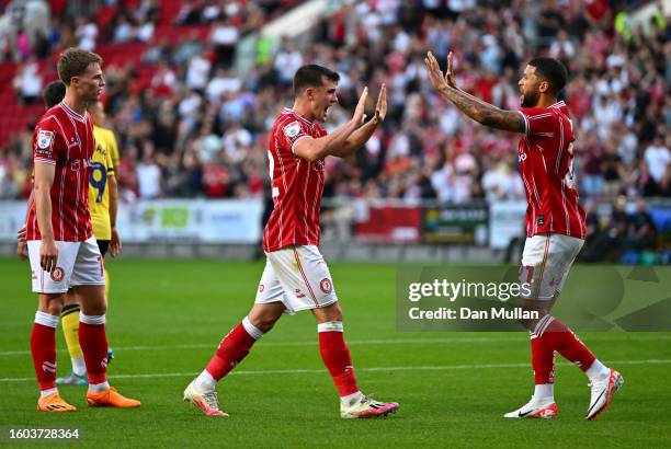 Jason Knight of Bristol City celebrates with teammate Nahki Wells after scoring the team's second goal during the Carabao Cup First Round match...