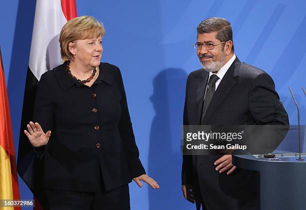 German Chancellor Angela Merkel and Egyptian President Mohamed Mursi depart after speaking to the media following talks at the Chancellery on January...