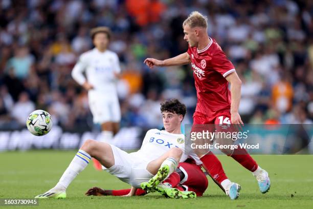 Archie Gray of Leeds United and Taylor Perry of Shrewsbury Town battle for possession during the Carabao Cup First Round match between Leeds United...