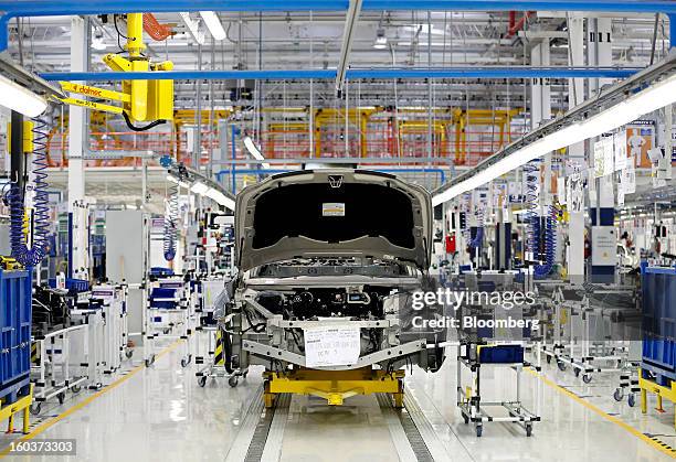 Maserati Quattroporte luxury automobile stands on the production line at Fiat SpA's Grugliasco factory in Turin, Italy, on Wednesday, Jan. 30, 2013....