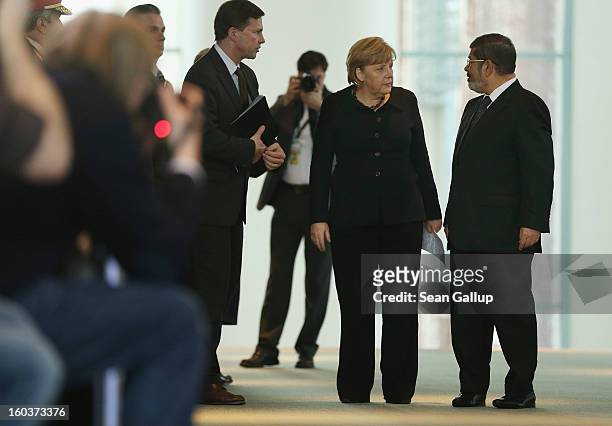 German Chancellor Angela Merkel and Egyptian President Mohamed Mursi arrive to speak to the media following talks at the Chancellery on January 30,...