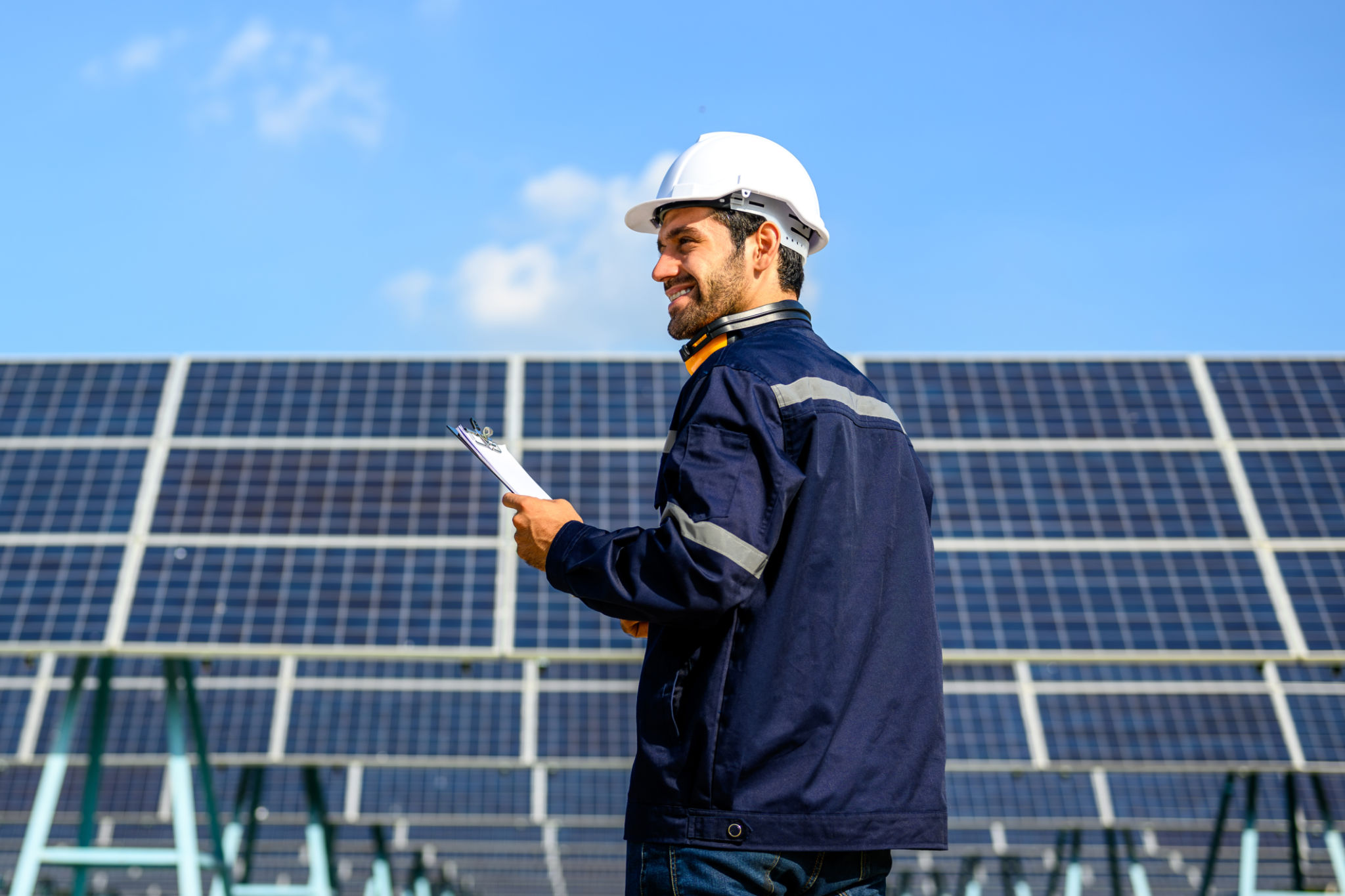 technician inspecting solar farm