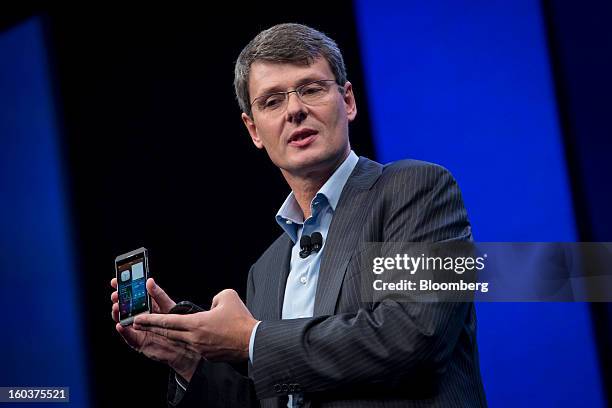 Thorsten Heins, chief executive officer of Research In Motion Ltd. , holds the BlackBerry 10 while speaking at the device's launch in New York, U.S.,...