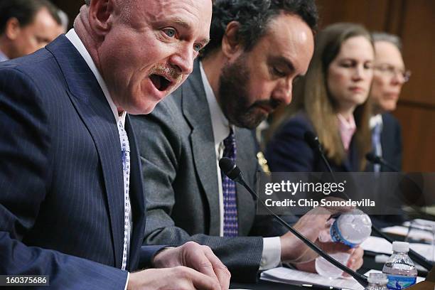 Retired NASA astronaut and Navy Capt. Mark Kelly delivers opening remarks with fellow witnesses Denver University Professor David Kopel, Independent...