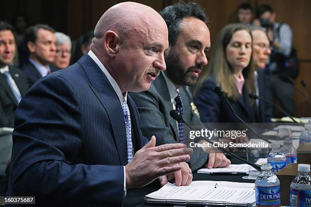 Retired NASA astronaut and Navy Capt. Mark Kelly delivers opening remarks with fellow witnesses Denver University Professor David Kopel, Independent...