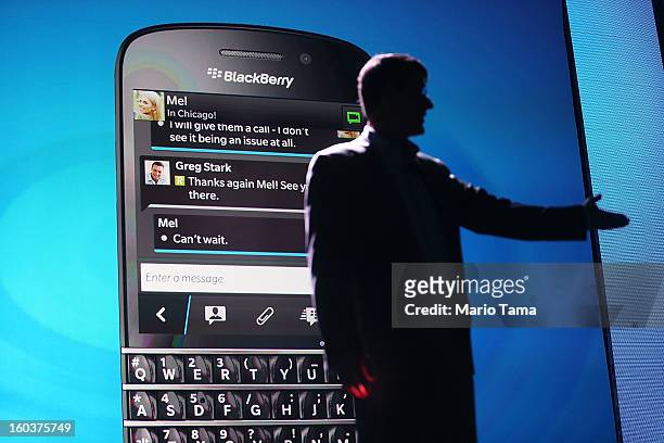 BlackBerry Chief Executive Officer Thorsten Heins speaks in front of a display of one of the new Blackberry 10 smartphones at the BlackBerry 10...