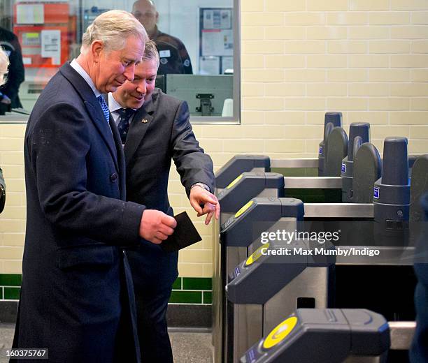 Prince Charles, Prince of Wales is shown how to use his Oyster Card to pass through the ticket gate at Farringdon Underground Station as he prepares...