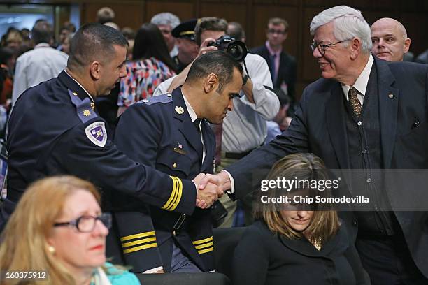 National Rifle Association President David Keene greets members of the Prince Georges County, Maryland, Police before a Senate Judiciary Committee...