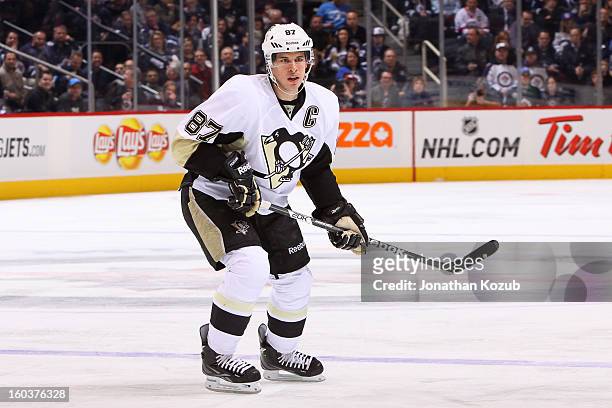 Sidney Crosby of the Pittsburgh Penguins keeps an eye on the play during first period action against the Winnipeg Jets at the MTS Centre on January...