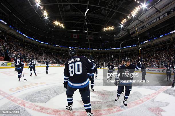 Members of the Winnipeg Jets salute the home crowd at centre ice following a 4--2 victory over the Pittsburgh Penguins at the MTS Centre on January...