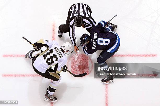 Brandon Sutter of the Pittsburgh Penguins gets set to take a face-off against Alexander Burmistrov of the Winnipeg Jets in second period action at...