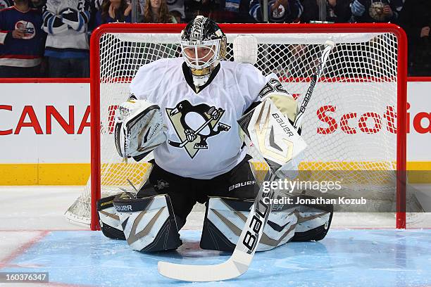 Goaltender Tomas Vokoun of the Pittsburgh Penguins stretches in the crease prior to NHL action against the Winnipeg Jets at the MTS Centre on January...