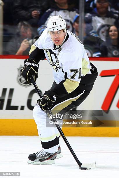 Evgeni Malkin of the Pittsburgh Penguins plays the puck during first period action against the Winnipeg Jets at the MTS Centre on January 25, 2013 in...