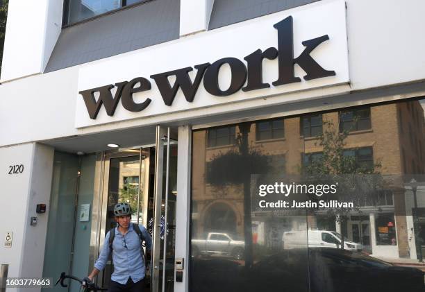 Person leaves a WeWork office on August 09, 2023 in Berkeley, California. New York-based workspace-sharing company WeWork says it has "substantial...