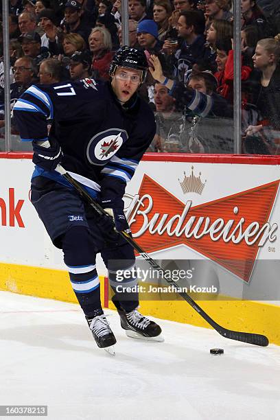 James Wright of the Winnipeg Jets plays the puck along the boards during third period action against the Pittsburgh Penguins at the MTS Centre on...