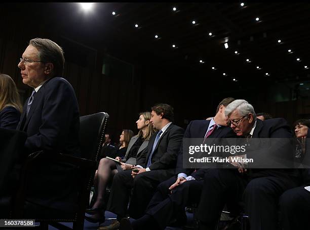 National Rifle Association President David Keene , speaks with aide while Wayne LaPierre sits at the witness table during a Senate Judiciary...