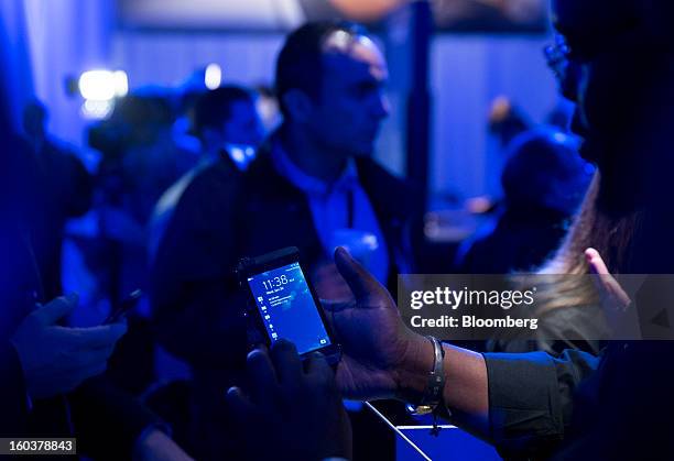 An attendee views the new BlackBerry 10 during the device's launch in New York, U.S., on Wednesday, Jan. 30, 2013. Research In Motion Ltd. , taking...