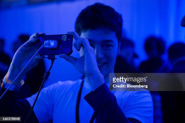 An attendee takes a picture with the new BlackBerry 10 during the device's launch in New York, U.S., on Wednesday, Jan. 30, 2013. Research In Motion...