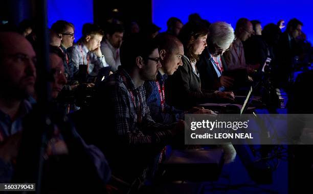 Journalists watch a live video stream of the presentation by BlackBerry president and CEO, Thorsten Heins, at one of eight simultaneous worldwide...