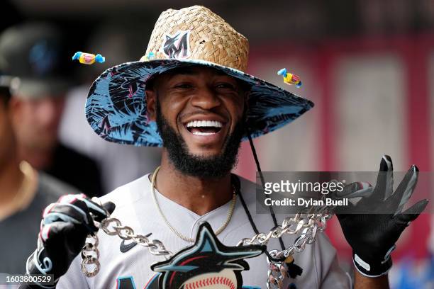 Bryan De La Cruz of the Miami Marlins celebrates in the dugout after hitting a home run in the ninth inning against the Cincinnati Reds at Great...