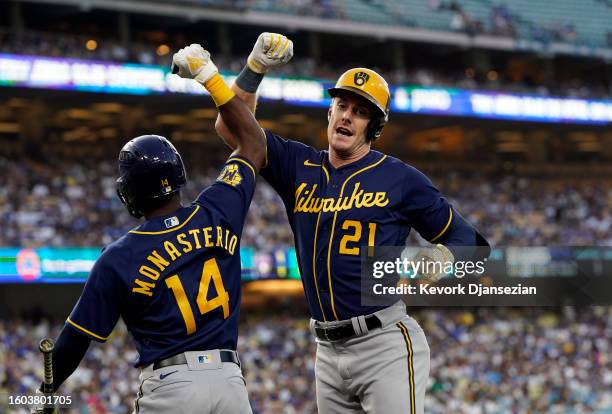 Mark Canha of the Milwaukee Brewers celebrates his solo home run with Andruw Monasterio against the Los Angeles Dodgers in the second inning at...