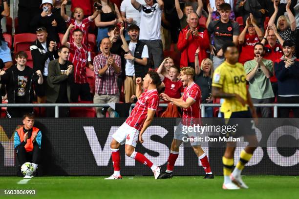 Kal Naismith of Bristol City celebrates with teammate Sam Bell after scoring the team's fifth goal during the Carabao Cup First Round match between...