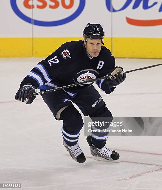 Olli Jokinen of the Winnipeg Jets skates down the ice during a game against the Pittsburgh Penguins on January 25, 2013 at the MTS Centre in...